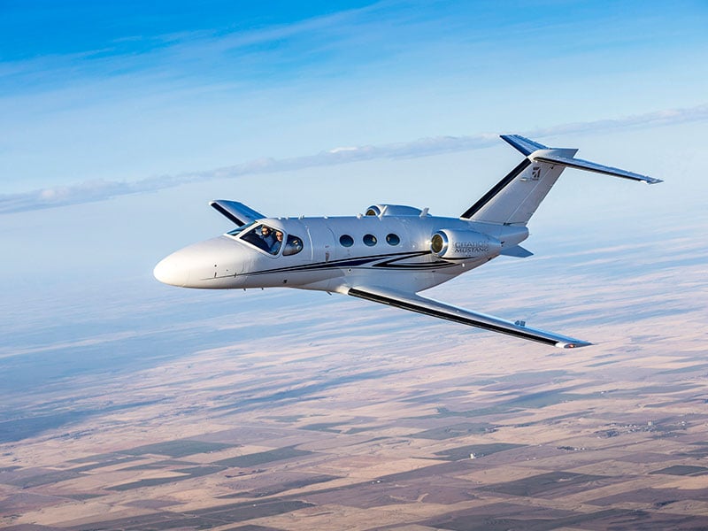 Cessna Citation Jet in flight above land