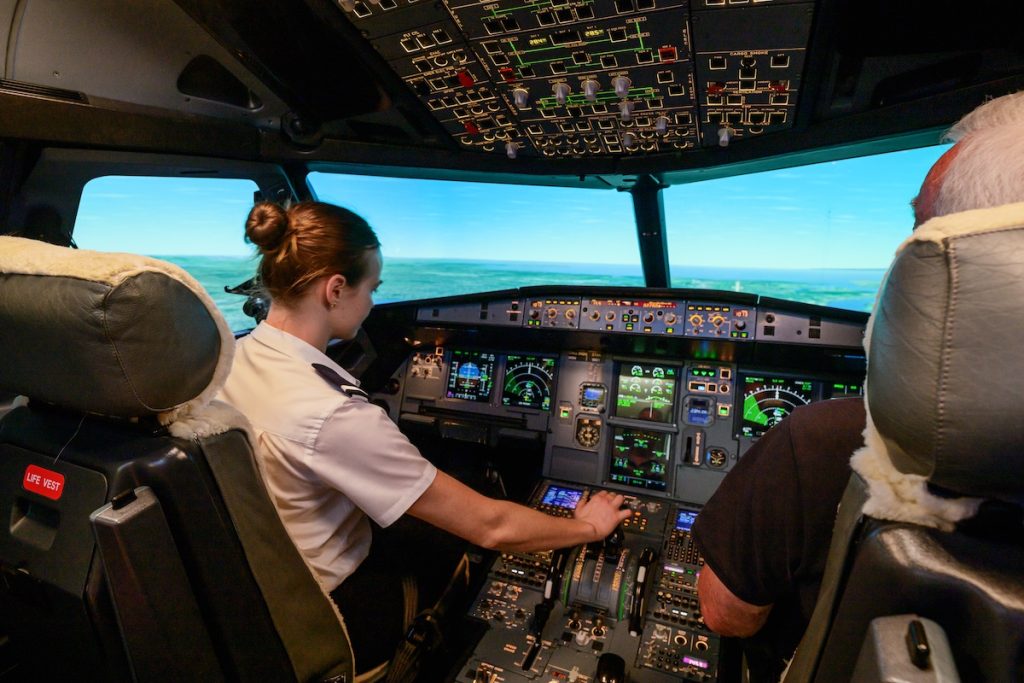 Pilot in airplane cockpit simulator as part of the Air Transport Pilot Licence (ATPL) course.