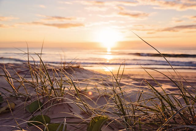 Sunshine Coast beach with sun setting over the ocean