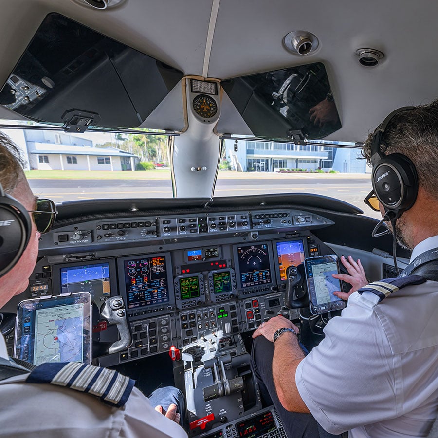Pilots on a private jet hire flight, preparing for take off.