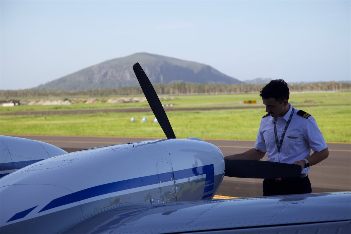 Pilot inspecting aircraft as part of specialised aviation training at Flight Options