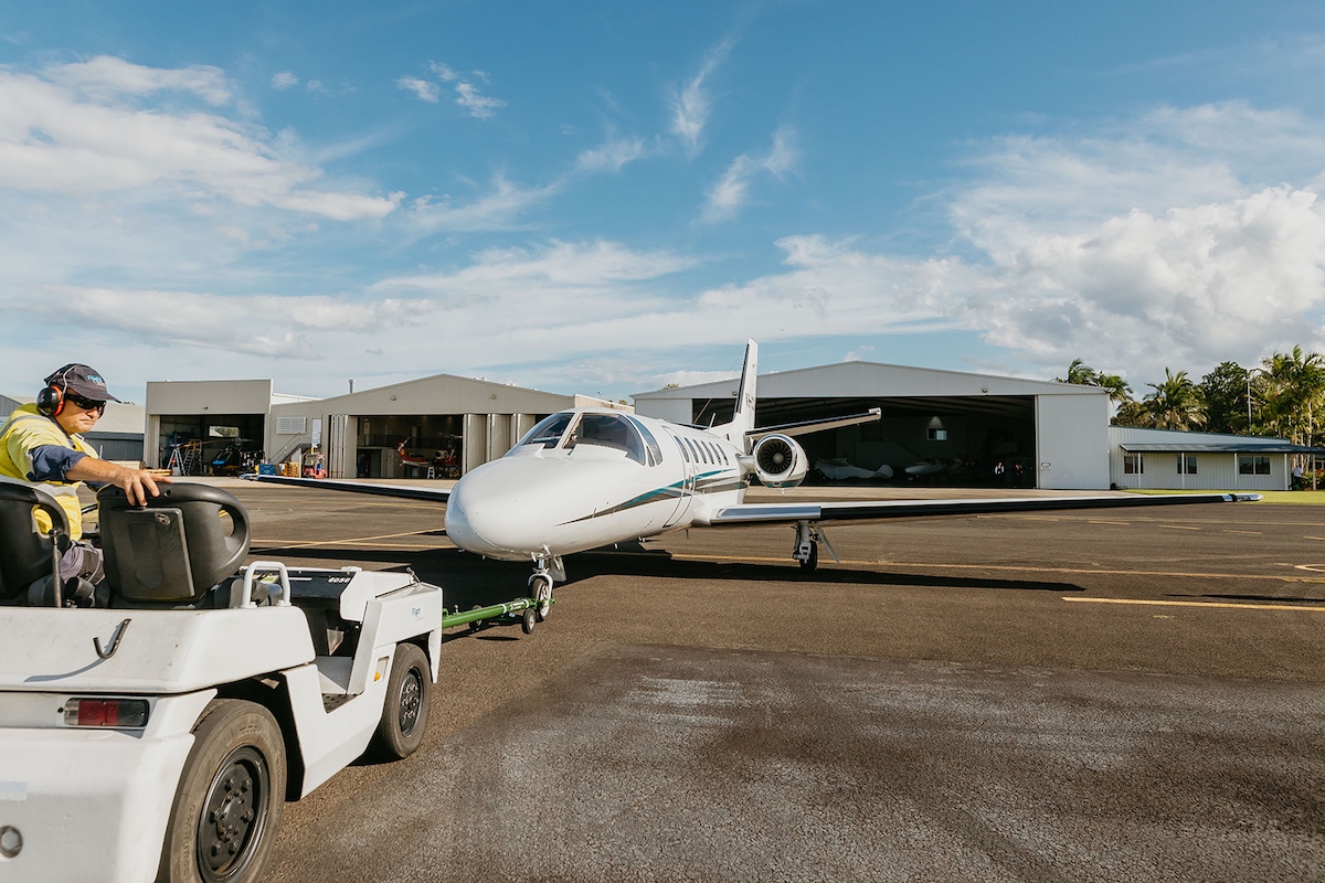 Towing a private jet at an airport.