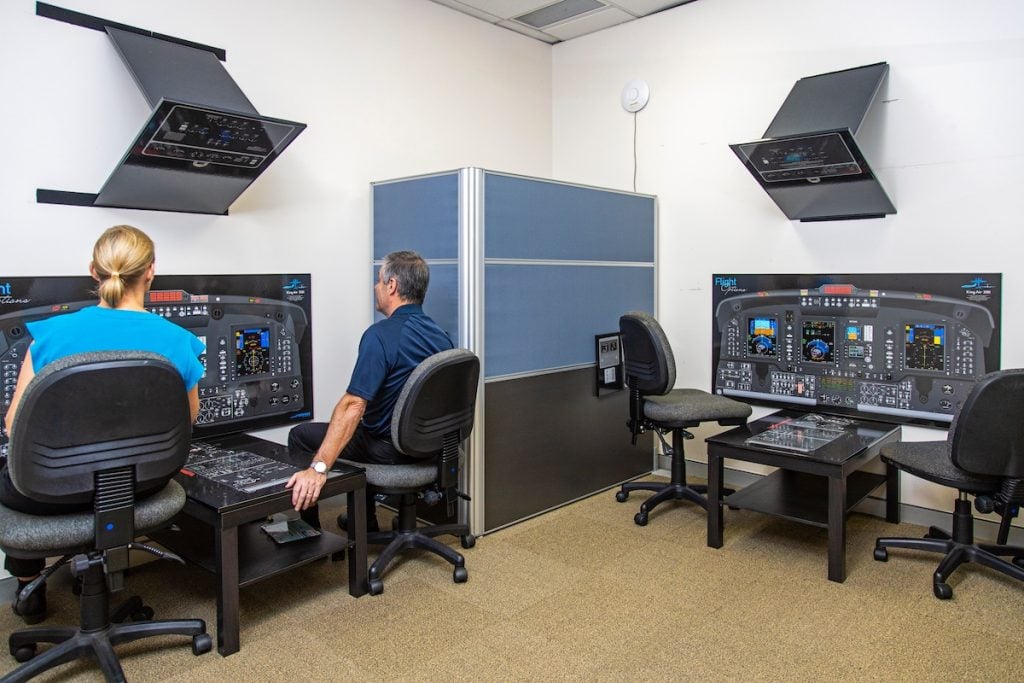 Flight simulator training room with aviation posters.
