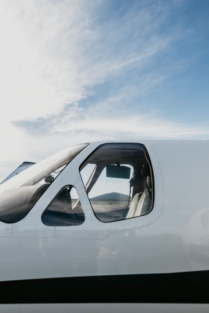 Airplane cockpit against a blue sky
